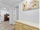 Hallway featuring neutral tones, storage furniture, and decorative art at 2723 Horseshoe Creek Sw Dr, Marietta, GA 30064
