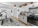 Well-lit kitchen with granite countertops, white cabinets, and stainless-steel appliances, perfect for cooking at 2723 Horseshoe Creek Sw Dr, Marietta, GA 30064