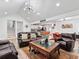 Bright, open-concept living area with modern lighting, hardwood floors, and a staircase leading to upper level at 2723 Horseshoe Creek Sw Dr, Marietta, GA 30064
