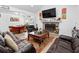 Cozy living room featuring a stone fireplace, comfortable leather seating, and a dining area in the background at 2723 Horseshoe Creek Sw Dr, Marietta, GA 30064