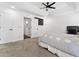 Main bedroom featuring tray ceiling, fan, and ensuite bathroom at 2723 Horseshoe Creek Sw Dr, Marietta, GA 30064