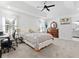 The main bedroom with tray ceilings, fan, and carpet at 2723 Horseshoe Creek Sw Dr, Marietta, GA 30064