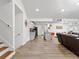 Spacious open floor plan connecting the living room, kitchen, and staircase with hardwood floors and ample lighting at 2723 Horseshoe Creek Sw Dr, Marietta, GA 30064