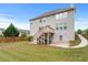 Spacious backyard featuring a two-story home, green grass, and a wood fence at 3422 Hopi Pt, Lawrenceville, GA 30044