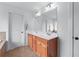 Bright bathroom with double sinks, a walk-in shower, and a door to the toilet at 3422 Hopi Pt, Lawrenceville, GA 30044