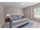 Bedroom showcasing a well-made bed, natural lighting and a neutral color palette at 3422 Hopi Pt, Lawrenceville, GA 30044