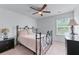 Bedroom showcasing a black metal bed frame, neutral bedding, and natural light from the window at 3422 Hopi Pt, Lawrenceville, GA 30044