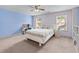 Bright bedroom featuring a ceiling fan, white furniture, and blue accent wall at 3422 Hopi Pt, Lawrenceville, GA 30044