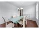 Dining area featuring hardwood floors and a glass top dining table at 3422 Hopi Pt, Lawrenceville, GA 30044