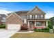 Charming two-story home featuring a brick and siding exterior, two-car garage, and inviting front porch at 3422 Hopi Pt, Lawrenceville, GA 30044