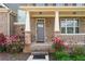 Inviting front porch featuring brick columns and colorful flowers at 3422 Hopi Pt, Lawrenceville, GA 30044