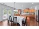 Kitchen dining area featuring hardwood floors, ample cabinets, granite countertops, and stainless steel appliances at 3422 Hopi Pt, Lawrenceville, GA 30044