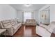 Cozy living room with hardwood floors, neutral walls, and plenty of seating at 3422 Hopi Pt, Lawrenceville, GA 30044
