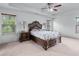 Spacious main bedroom with tray ceilings, a ceiling fan, carpet, and natural light at 3422 Hopi Pt, Lawrenceville, GA 30044