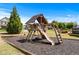 Community playground with slide, swings, and wood chip ground covering at 3422 Hopi Pt, Lawrenceville, GA 30044