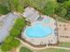 Aerial view showcases community pool and playground, set among beautiful greenery and landscaping at 121 Camdyn Cir, Woodstock, GA 30188