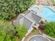 Aerial view showcasing the community pool and clubhouse, surrounded by lush greenery and landscaping at 121 Camdyn Cir, Woodstock, GA 30188
