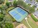 Aerial view featuring the community tennis courts, surrounded by mature trees and landscaping at 121 Camdyn Cir, Woodstock, GA 30188