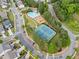 Aerial view of the community, featuring the pool, playground, tennis courts, and surrounding neighborhood at 121 Camdyn Cir, Woodstock, GA 30188
