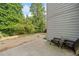 Simple backyard with a concrete patio, overlooking grassy area with shade trees and open sky at 121 Camdyn Cir, Woodstock, GA 30188