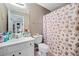Functional bathroom with a white vanity, toilet, and shower curtain featuring a seashell pattern at 121 Camdyn Cir, Woodstock, GA 30188