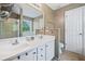 Bathroom with dual sinks, a large mirror, and a glass door walk-in shower, and toilet at 121 Camdyn Cir, Woodstock, GA 30188