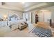 Spacious main bedroom with sitting area, tray ceilings, and an attached closet room at 121 Camdyn Cir, Woodstock, GA 30188