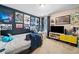 Fun bedroom featuring movie posters, a large TV, string lights, and a comfy bed with blue plushies at 121 Camdyn Cir, Woodstock, GA 30188