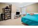 Comfortable bedroom with a cozy bed, neutral walls, and practical furnishings like a bookcase and TV stand at 121 Camdyn Cir, Woodstock, GA 30188