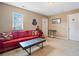 Bonus room with carpeted flooring, a comfortable red couch, and neutral color scheme at 121 Camdyn Cir, Woodstock, GA 30188
