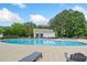 Relaxing community pool area with lounge chairs, tables, and umbrellas for residents' enjoyment at 121 Camdyn Cir, Woodstock, GA 30188