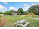 Well-maintained community space with a playground, green lawn, and picnic tables for residents at 121 Camdyn Cir, Woodstock, GA 30188