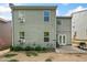 Back exterior of the two-story home with a patio, grill, and expansive grassy yard at 121 Camdyn Cir, Woodstock, GA 30188