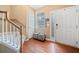Inviting foyer with hardwood floors, staircase, and decorative accents, leading to other parts of the home at 121 Camdyn Cir, Woodstock, GA 30188