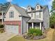 Charming two-story home showcasing manicured landscaping, a gray exterior, and a convenient two-car garage at 121 Camdyn Cir, Woodstock, GA 30188