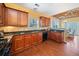 Well-equipped kitchen with dark countertops and wood cabinetry, adjacent to dining area at 121 Camdyn Cir, Woodstock, GA 30188