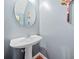 Powder room with pedestal sink, modern faucet, oval mirror and grey wall at 121 Camdyn Cir, Woodstock, GA 30188
