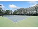 Community tennis court with lighting and seating, offering recreational opportunities for residents at 121 Camdyn Cir, Woodstock, GA 30188