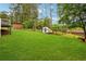 Expansive backyard featuring lush green lawn, storage shed, and mature trees, ready for outdoor enjoyment at 2240 Clanton Ter, Decatur, GA 30034