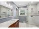 Updated bathroom featuring a glass enclosed shower with white marble tiles and a carved wood vanity with a marble countertop at 2240 Clanton Ter, Decatur, GA 30034