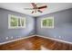 Bedroom featuring hardwood floors, a ceiling fan, two windows with blinds and neutral wall paint at 2240 Clanton Ter, Decatur, GA 30034