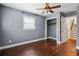 Bedroom featuring wood floors, neutral walls, a bright window, closet, and an open door with stairs at 2240 Clanton Ter, Decatur, GA 30034