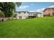 Spacious backyard featuring a well-maintained lawn, fencing, mature trees and home view at 2240 Clanton Ter, Decatur, GA 30034