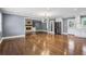 Open-concept living room with hardwood floors, a stone fireplace, and modern lighting fixtures at 2240 Clanton Ter, Decatur, GA 30034