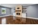 Cozy living room with a stone fireplace, hardwood floors, and built-in shelving for a stylish look at 2240 Clanton Ter, Decatur, GA 30034