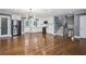 Open layout featuring hardwood floors, a modern kitchen with white cabinets, and staircase access at 2240 Clanton Ter, Decatur, GA 30034