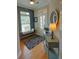 Inviting entryway featuring hardwood floors, a stylish console table, and a cozy bench, bathed in natural light at 2771 Middlecreek Way, Cumming, GA 30041