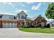 Charming two-story home featuring a brick and stone facade with a well-manicured lawn and attached two-car garage at 2771 Middlecreek Way, Cumming, GA 30041