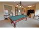 Clubhouse game room with a classic pool table, comfortable seating, and elegant lighting at 2771 Middlecreek Way, Cumming, GA 30041