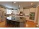 Bright kitchen featuring white cabinets, stainless steel appliances, granite counters, and an island at 2771 Middlecreek Way, Cumming, GA 30041